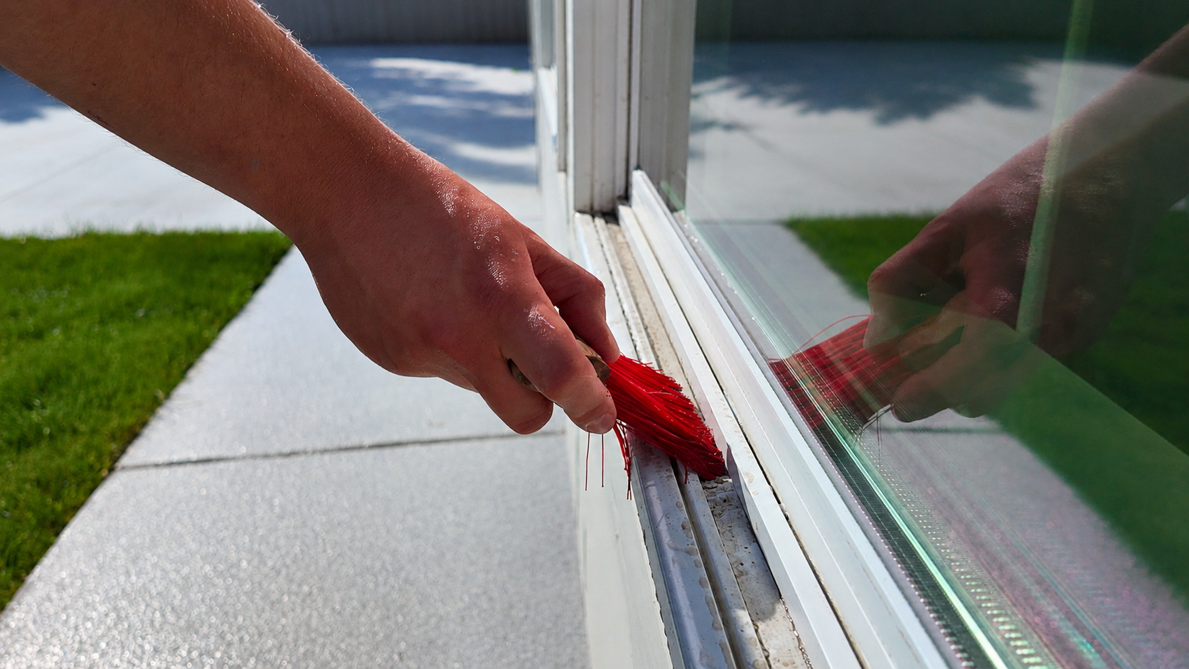 Detail brush cleaning dirt and debris from a window sill track