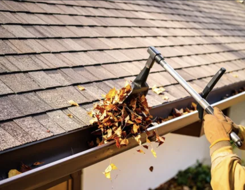 Gutters being cleared of leaves and debris on a sunny day